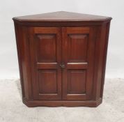 Oak corner cupboard with two panelled doors, the whole on bracket feet, 92cm high