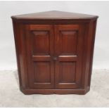 Oak corner cupboard with two panelled doors, the whole on bracket feet, 92cm high