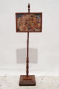 Early 20th century oak polescreen with needlework and patchwork decoration, on turned supports,
