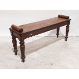 Walnut window seat with scroll ends above the rectangular top with canted corners, on turned and