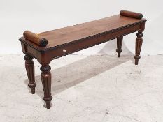 Walnut window seat with scroll ends above the rectangular top with canted corners, on turned and