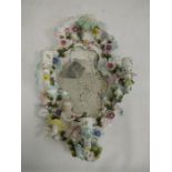 19th century porcelain wall mirror with three candle sconces, floral encrusted decoration and relief