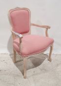 Modern French-style bedroom chair with pink upholstered seat and back, lime-washed frame