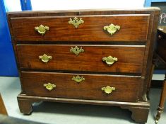 19th century mahogany chest of three drawers, the rectangular top with canted front corners,