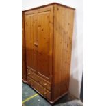 Pair of 20th century pine wardrobes, one with two drawers under (2)