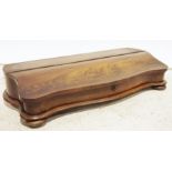 19th century flame mahogany box with lift top compartment, serpentine front, on squat bun feet, 73cm