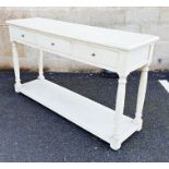 Cream painted hall table, the rectangular top with moulded edge above three drawers, on turned