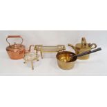 Two brass trivets, a brass watering can, a copper kettle and two brass saucepans