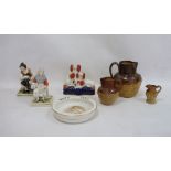 Three stoneware jugs, Staffordshire flatware spaniel group, pair of figures and a baby plate 'HRH
