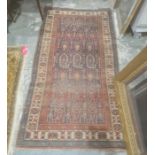 Eastern rug with blue ground central field with hooked repeating medallions, stepped border, 196cm x