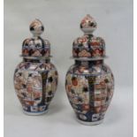 Pair Japanese Imari vases, each ovoid and ribbed with typical decoration in panels, having high