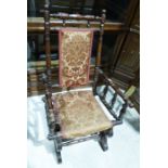 Early 20th century child's rocking chair with turned frame, upholstered seat and back