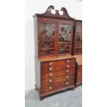 George III mahogany secretaire bookcase with swan-neck pediment above astragal glazed doors