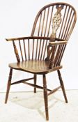 Elm-seated wheelback Windsor-type elbow chair on turned supports and stretcher