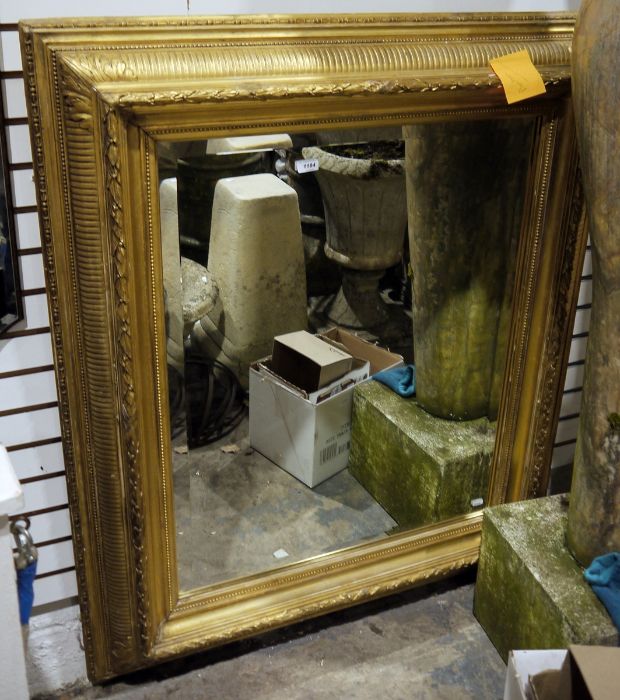 Possibly late 19th century rectangular mirror with bevel-edge plate glass, heavily moulded gilt