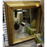 Possibly late 19th century rectangular mirror with bevel-edge plate glass, heavily moulded gilt