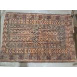 Eastern rug with black ground, red, orange and cream decoration, 120cm x 86cm