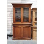 Late 19th century mahogany bookcase cabinet, the moulded cornice above two glazed doors enclosing