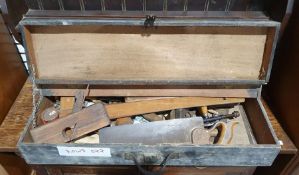 Wooden tool box containing various vintage hand tools