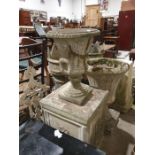 Stone urn on a plinth base together with two further stone urns (3)