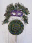 Peacock feather mask, a peacock feather circular fan and an Oriental silk feather and painted fan