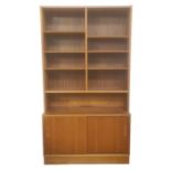 Mid 20th century Danish Hundevad bookcase with nine shelves above pair of sliding panelled