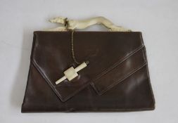 Brown leather vintage bag, the fixed bakelite handle formed as a running greyhound, the bakelite