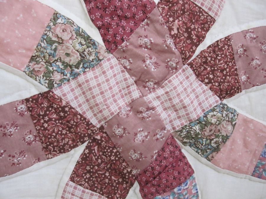 Modern patchwork quilt in pinks and maroons on a white ground and a small circular sewing basket ( - Image 2 of 5