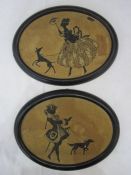 Pair of oval silhouette embroidered pictures depicting male and female figures walking a dog, 16.5cm