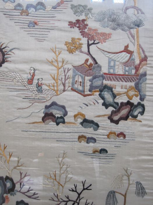 20th century Chinese embroidered silk panel, the beige ground depicting various landscape scenes,