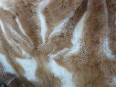 Guanaco (llama) fur throw backed by gold-coloured satin, labelled 'Hockley', 231cm x 241cm and two