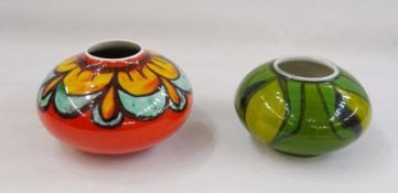 Two Poole pottery squat vases, shape no. 32, one orange ground and one green (2) 12cm and 10cm