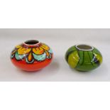 Two Poole pottery squat vases, shape no. 32, one orange ground and one green (2) 12cm and 10cm