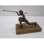 Bronzed-effect abstract figure of warrior with spear and shield, on wooden base, 30cm wide x 19cm