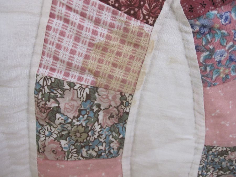 Modern patchwork quilt in pinks and maroons on a white ground and a small circular sewing basket ( - Image 3 of 5