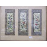 Three Chinese embroidered panels framed as one, depicting birds, flowers and insects within a
