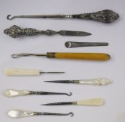 Silver-handed button hook, a silver-handled file, mother-of-pearl hooks, etc (1 box)