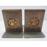 Pair Arts and Crafts carved wooden and engraved metal bookends, each with stylised fruit carved