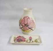 Moorcroft pottery vase, baluster-shaped with slip trails magnolia decoration on a cream ground, 20cm