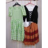 Quantity of assorted theatrical costume to include Gingham milkmaid-style dresses, velvet,