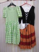 Quantity of assorted theatrical costume to include Gingham milkmaid-style dresses, velvet,
