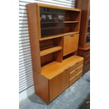 Mid century McIntosh teak lounge unit with sliding glass doors above fall and shelves, the base of