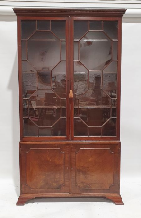 19th century mahogany bookcase, the moulded cornice above the astragal glazed doors enclosing