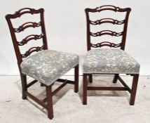 Pair of Georgian-style ladderback dining chairs with carved and pierced decoration, upholstered