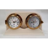 Sewills clock and barometer mounted in ship's brass bulkhead-type surround