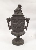 Bronze two-handled urn decorated with a continuous band of cherubs in a Bacchanalian scene, the