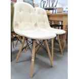 Set of four modern dining chairs with cream leather upholstered seats and back, on turned beech