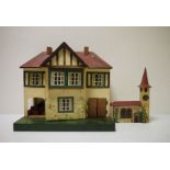 A Triang painted doll's house, 42cm high with wooden painted clock tower (2)