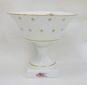 Limoges porcelain pedestal bowl with printed floral decoration, gilt rim, raised on square base,