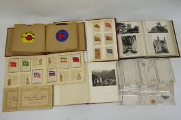 Album and contents of Kensitas cigarette silks depicting flags of the British Empire, a postcard